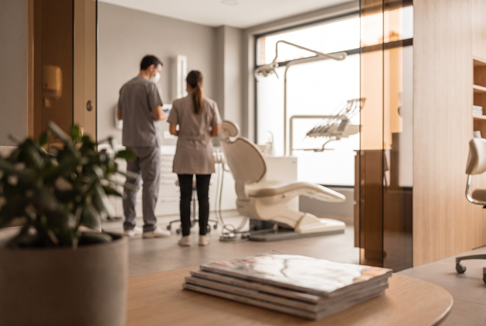 A dental practice reception area in warm light.